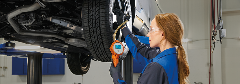 A Subaru technician checking tire pressure. | Wallace Subaru - Johnson City in Johnson City TN