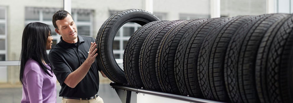 Subaru service representative showing customer a tire. | Wallace Subaru - Johnson City in Johnson City TN