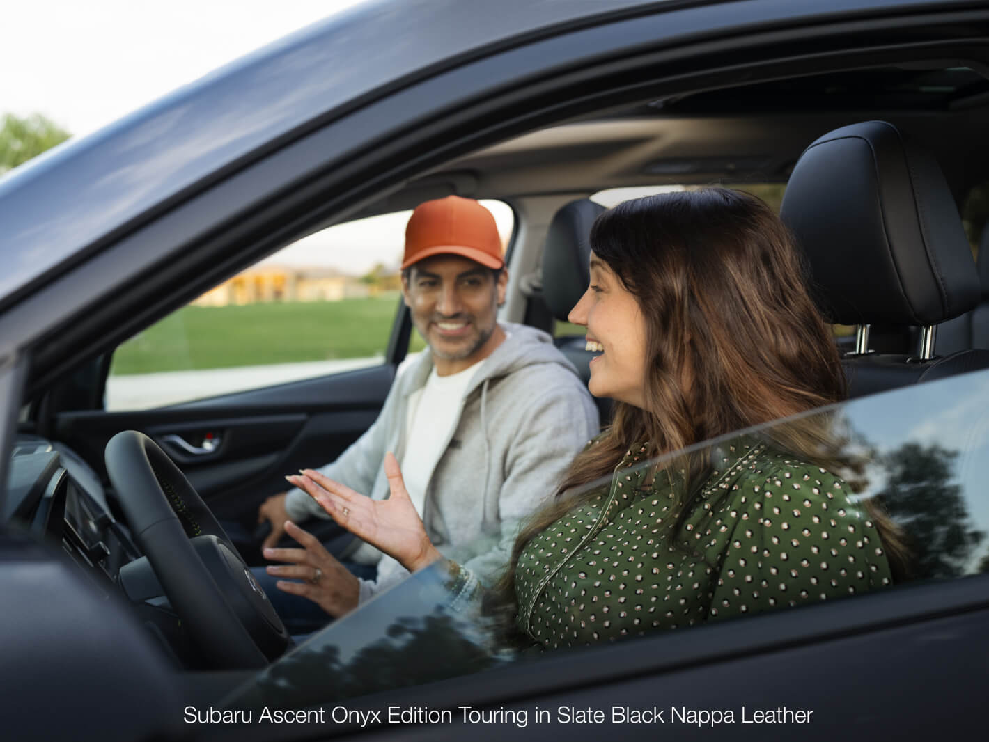 Couple smiling and chatting in the Subaru Ascent Onyx Edition Touring in Slate Black Nappa Leather