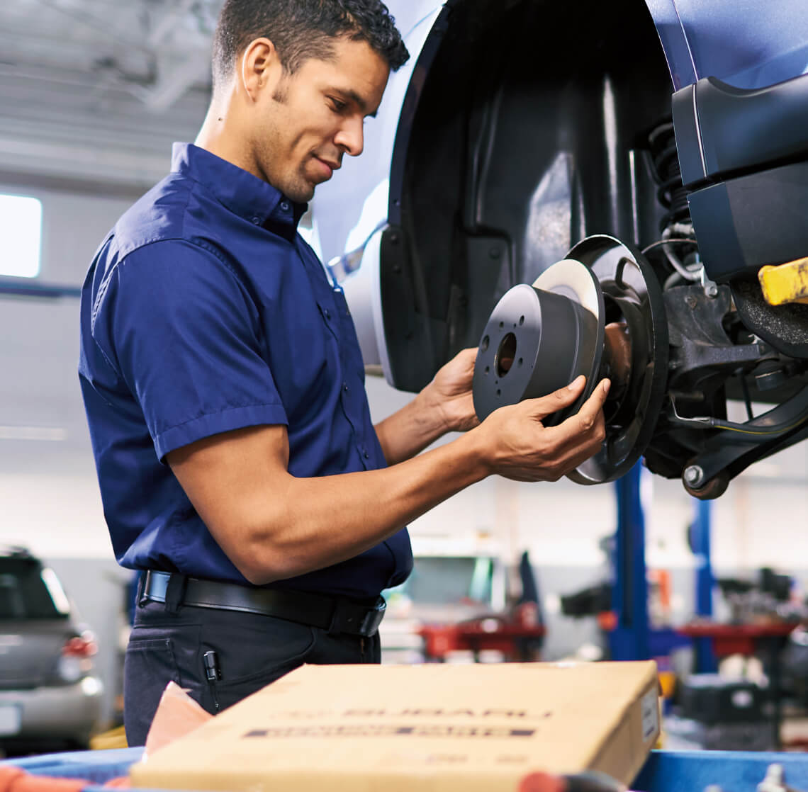 Subaru certified technician performing maintenance on a Subaru Vehicle
